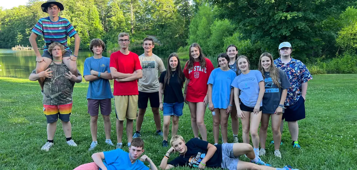 The whole Teen Retreat group posed together on the grass beside the lake