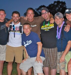 Brent with a group of fellow DFC campers and counselors, arms around each other at camp
